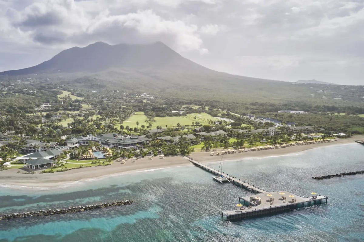 aerial view of a beach on a lush island