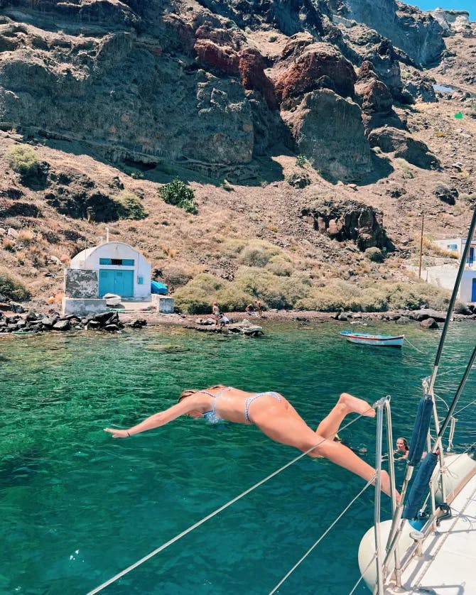 Travel advisor jumping in a lake to swim