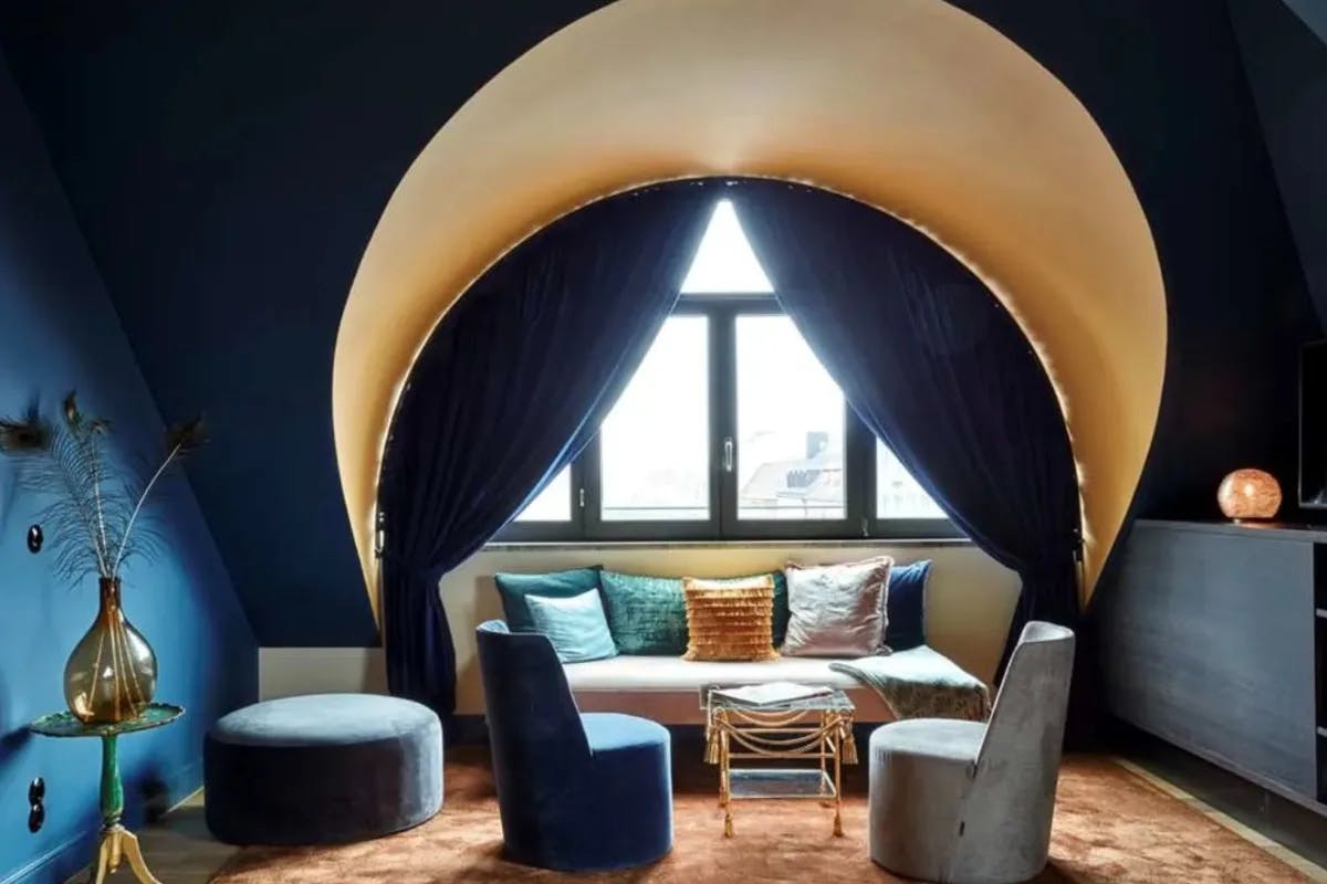 navy blue rooms with an arched window, a couch and chairs