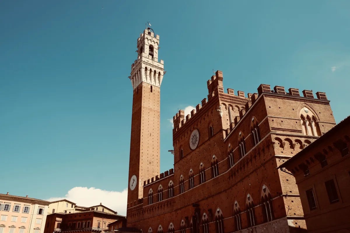 Brown building under blue sky photo.