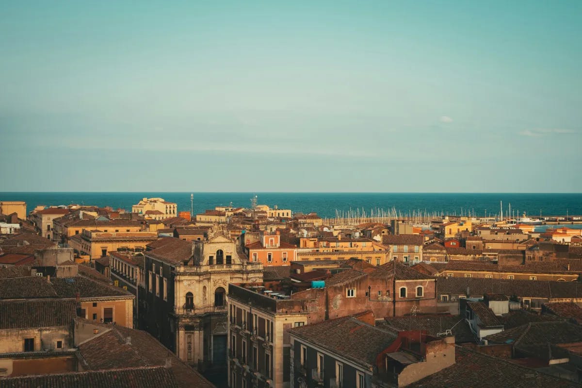 The city with the ocean and vast blue sky in the background.