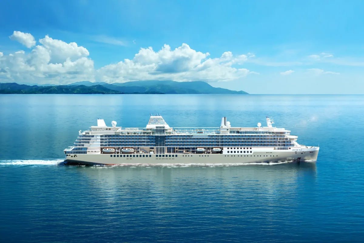 large cruise ship in blue ocean with blue sky and clouds