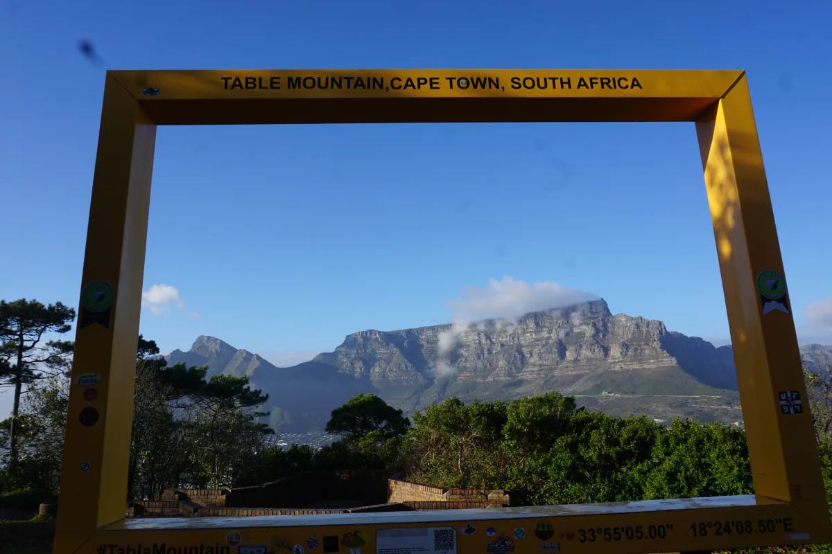 A big yellow frame installation through which Table Mountain can be seen on a clear day.