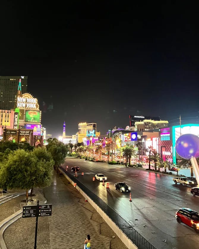 View of illuminated Las Vegas strip at night with brighly lit buildings and cars driving