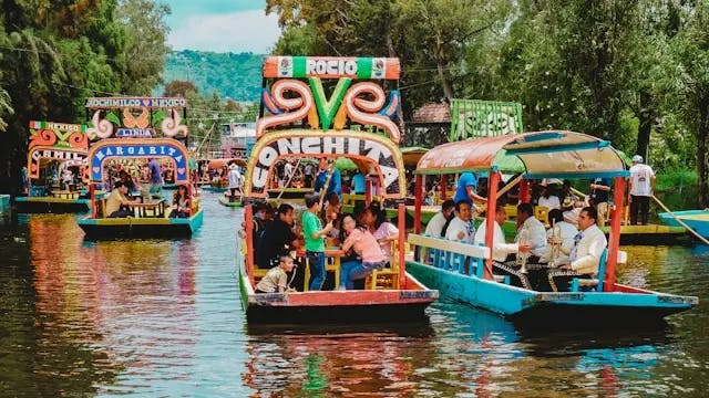 Colorful decorated boats of people on a body of water during the daytime