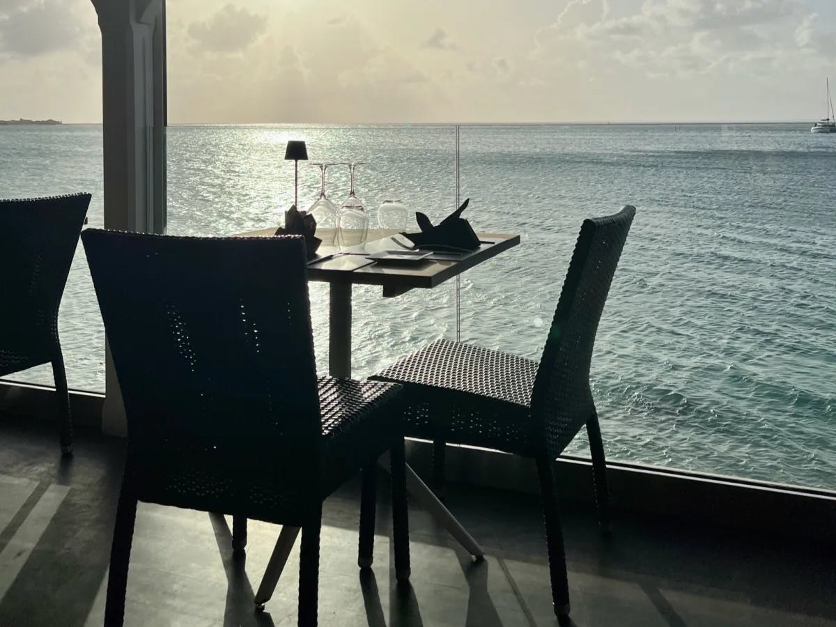 Restaurant with ocean view out of glass wall.