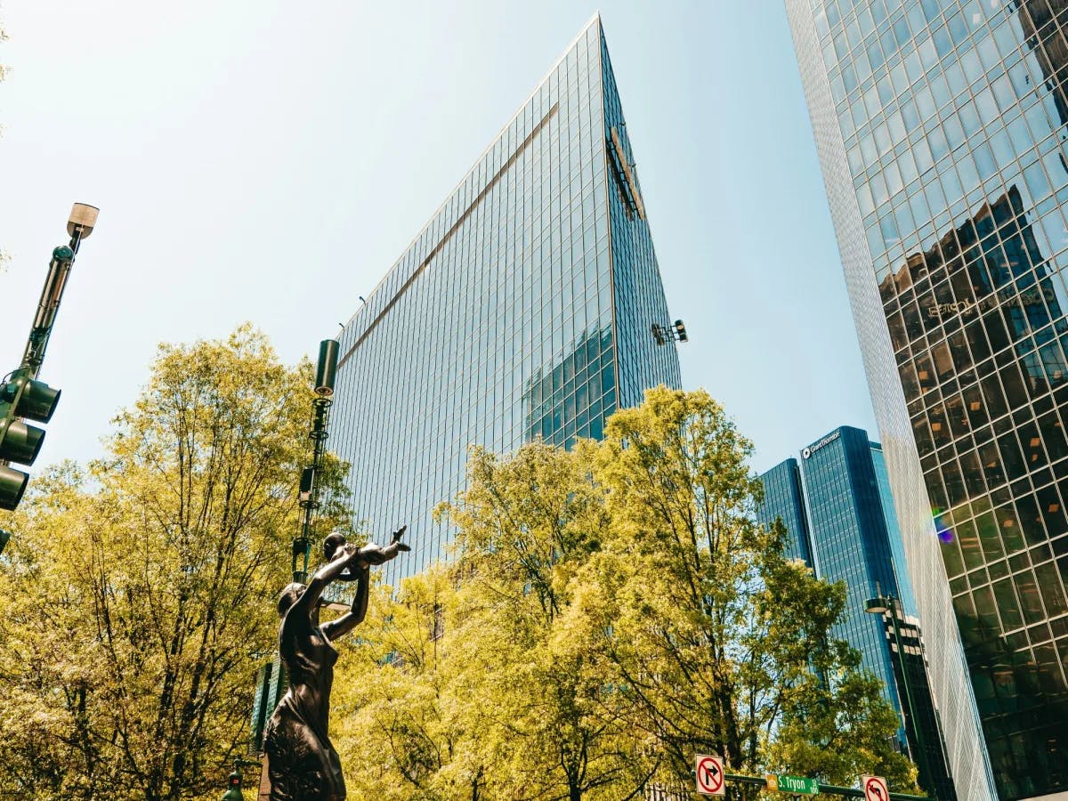 High rise buildings surrounded by trees during the daytime.