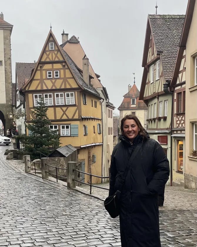 photo in front of buildings in a very cute town with cobble stone streets.