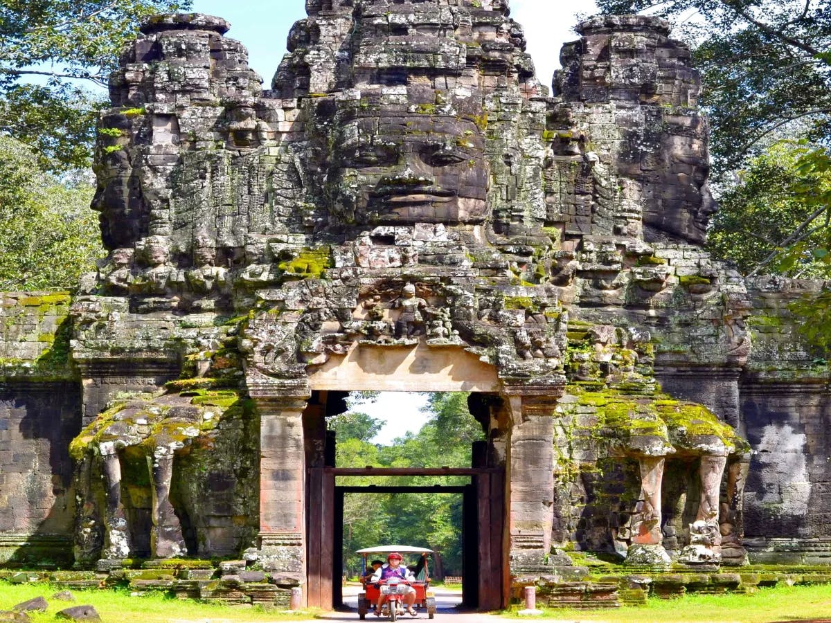 A picture of a brown-colored temple of concrete near trees.