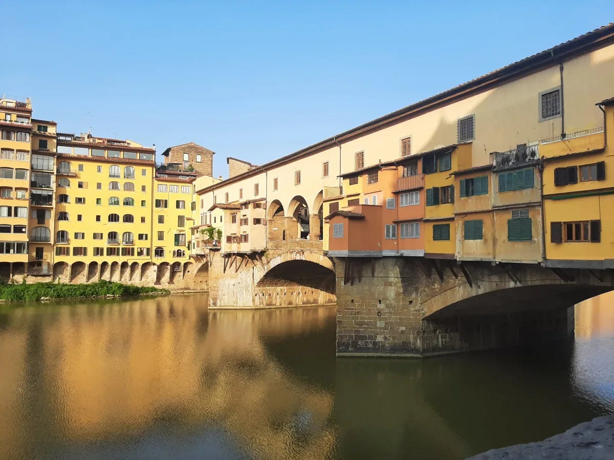 The Ponte Vecchio in Italy above a river. 