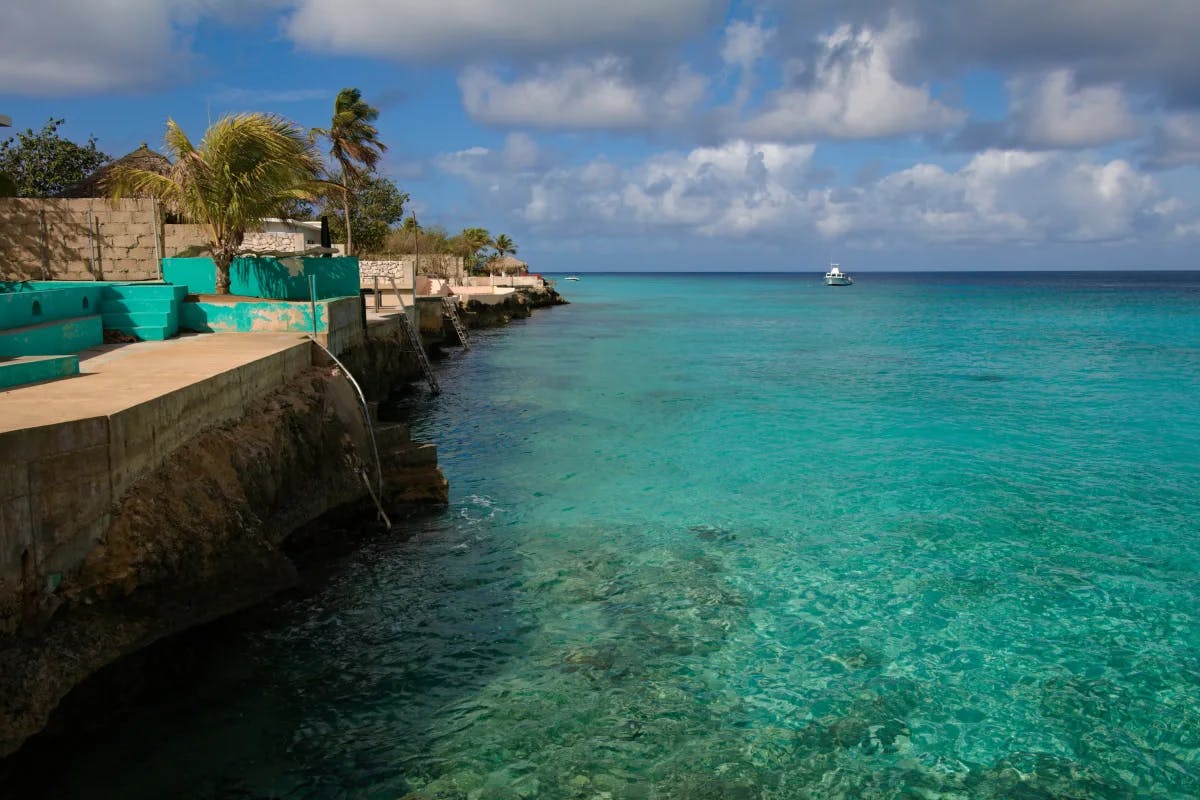 A reef in the island with trees and blue sky in the view