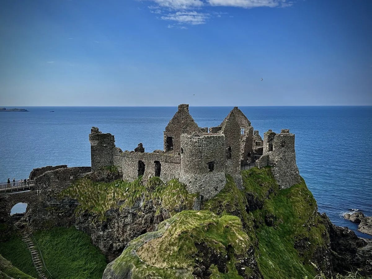 A grey castle on a sea shore. 