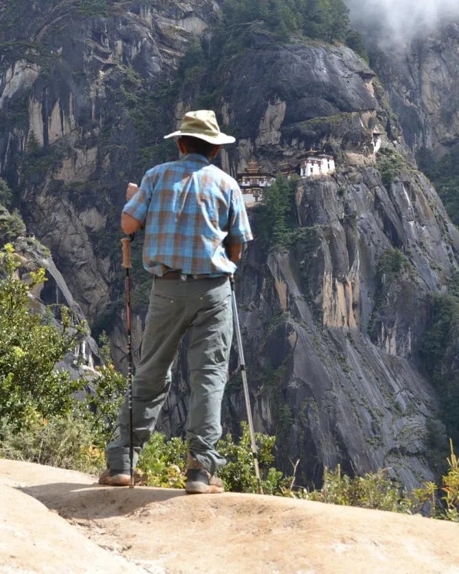 Picture of Arun hiking with a view of The tiger nest Bhutan