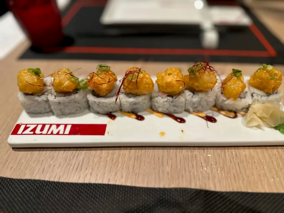 Sushi on a tray that reads "Izumi."