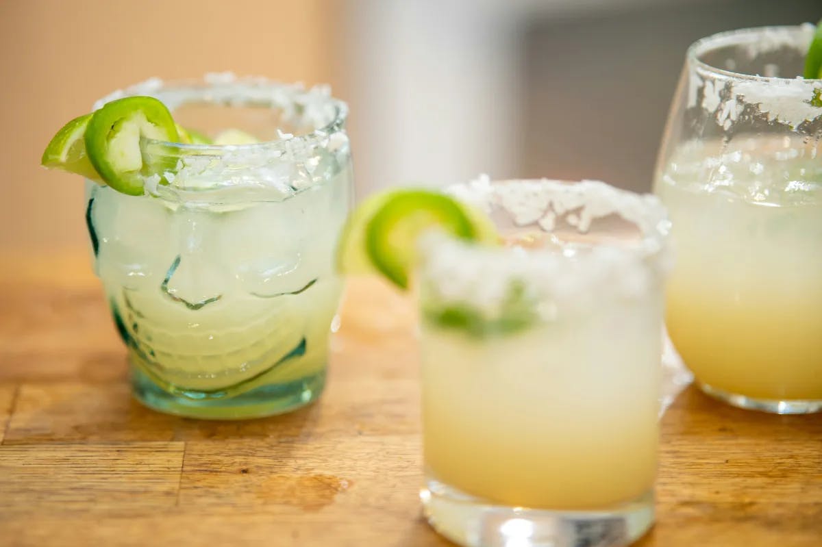 Margaritas on ice on a wooden table on a staycation in Scottsdale. 