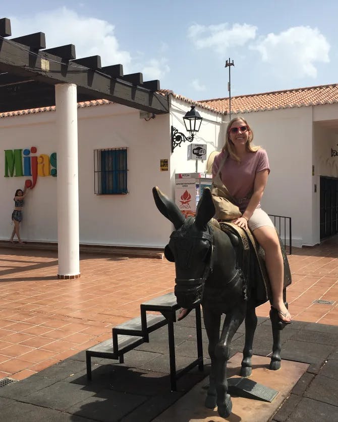 Travel advisor sitting on the back of a donkey