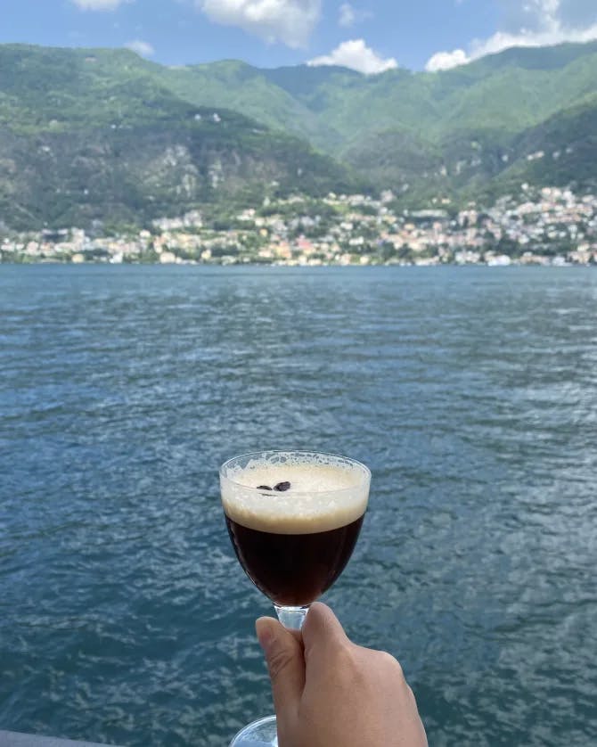 Picture of a glass in hand with sea view