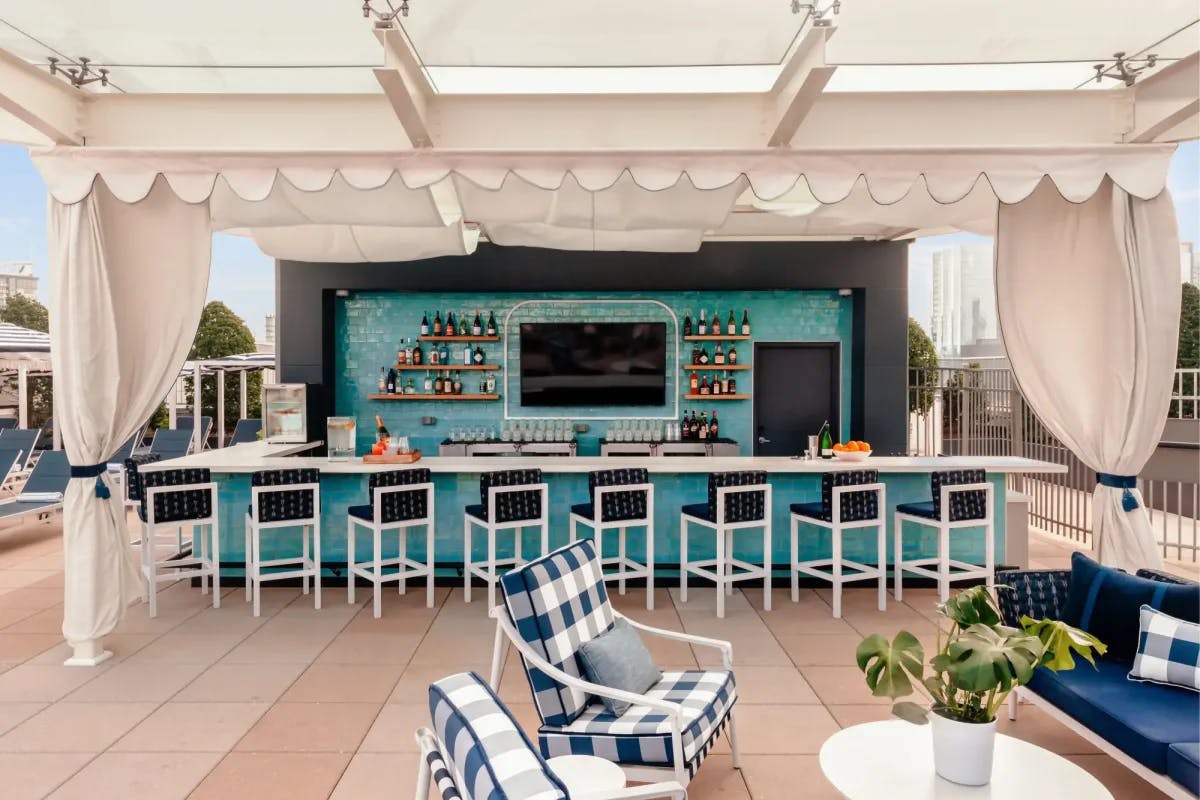Colorful and fun rooftop bar with chic seating arrangements and an excellent selection of alcohol