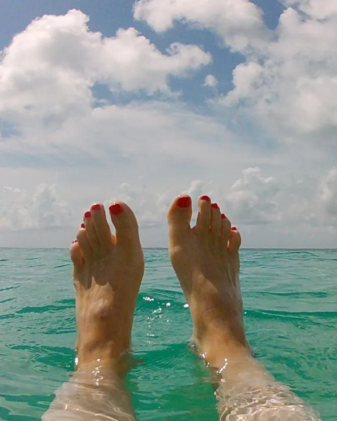 Feet view beside in the sea