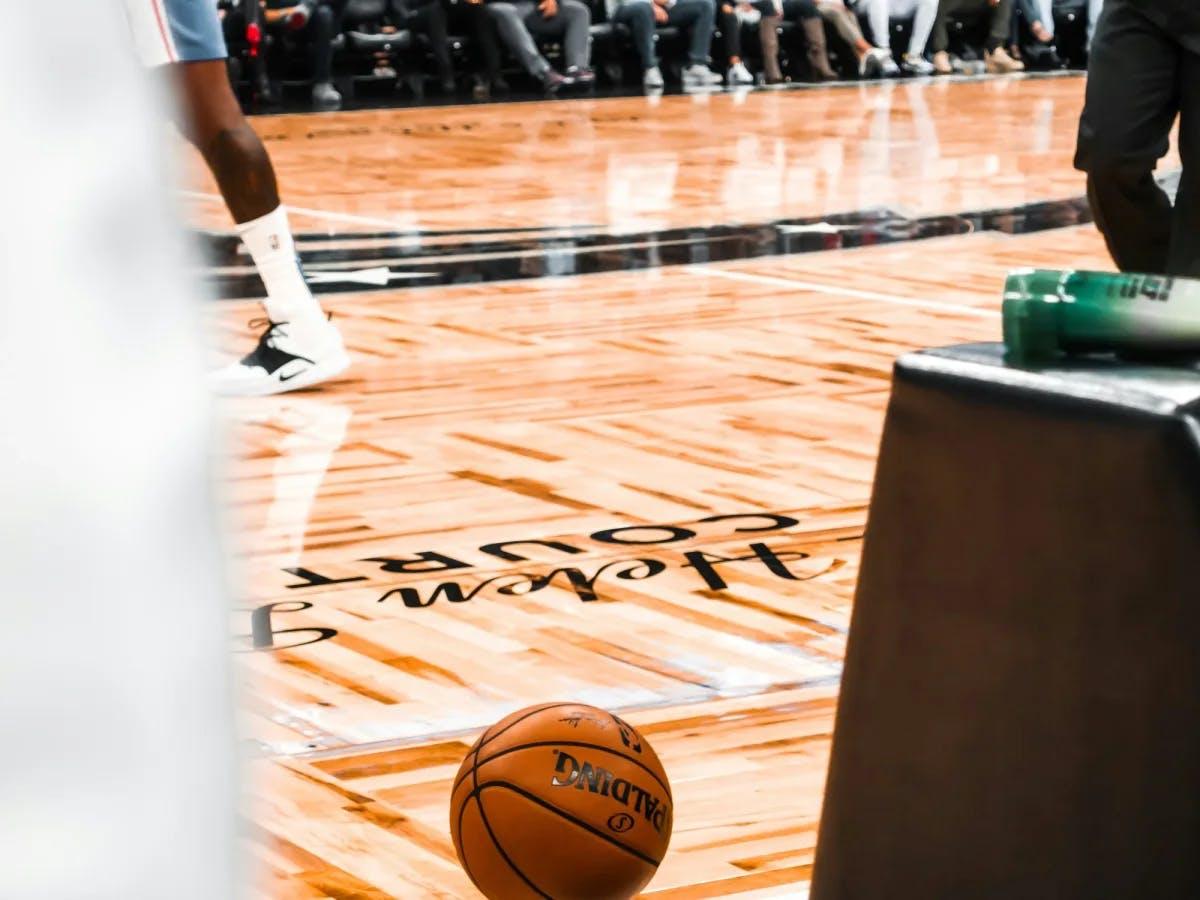 A basketball sitting on the floor of a basketball court