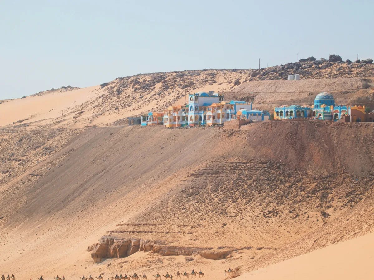 A group of buildings on a hill in desert. 