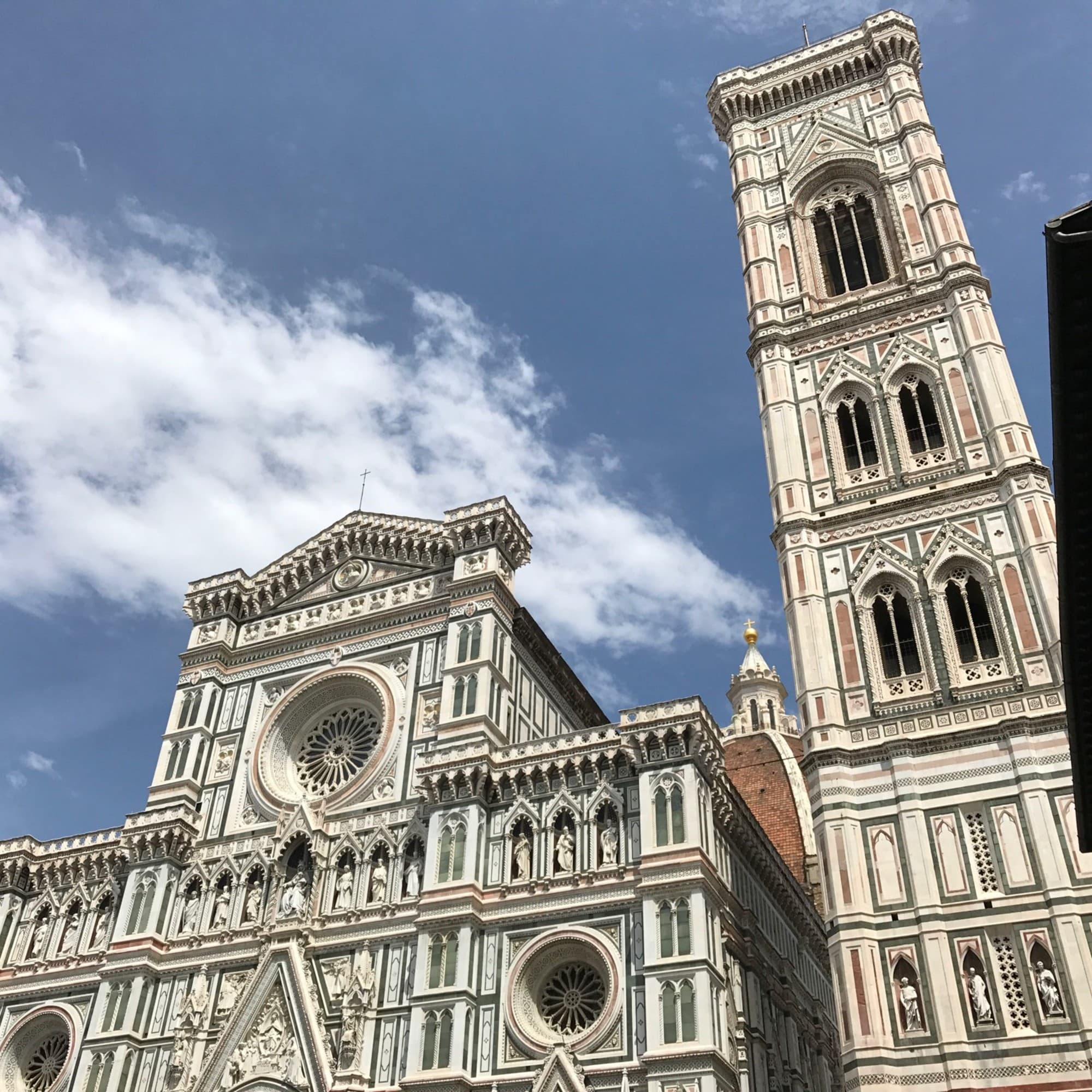 A low-angled view of a cathedral-like building under a blue sky during the daytime