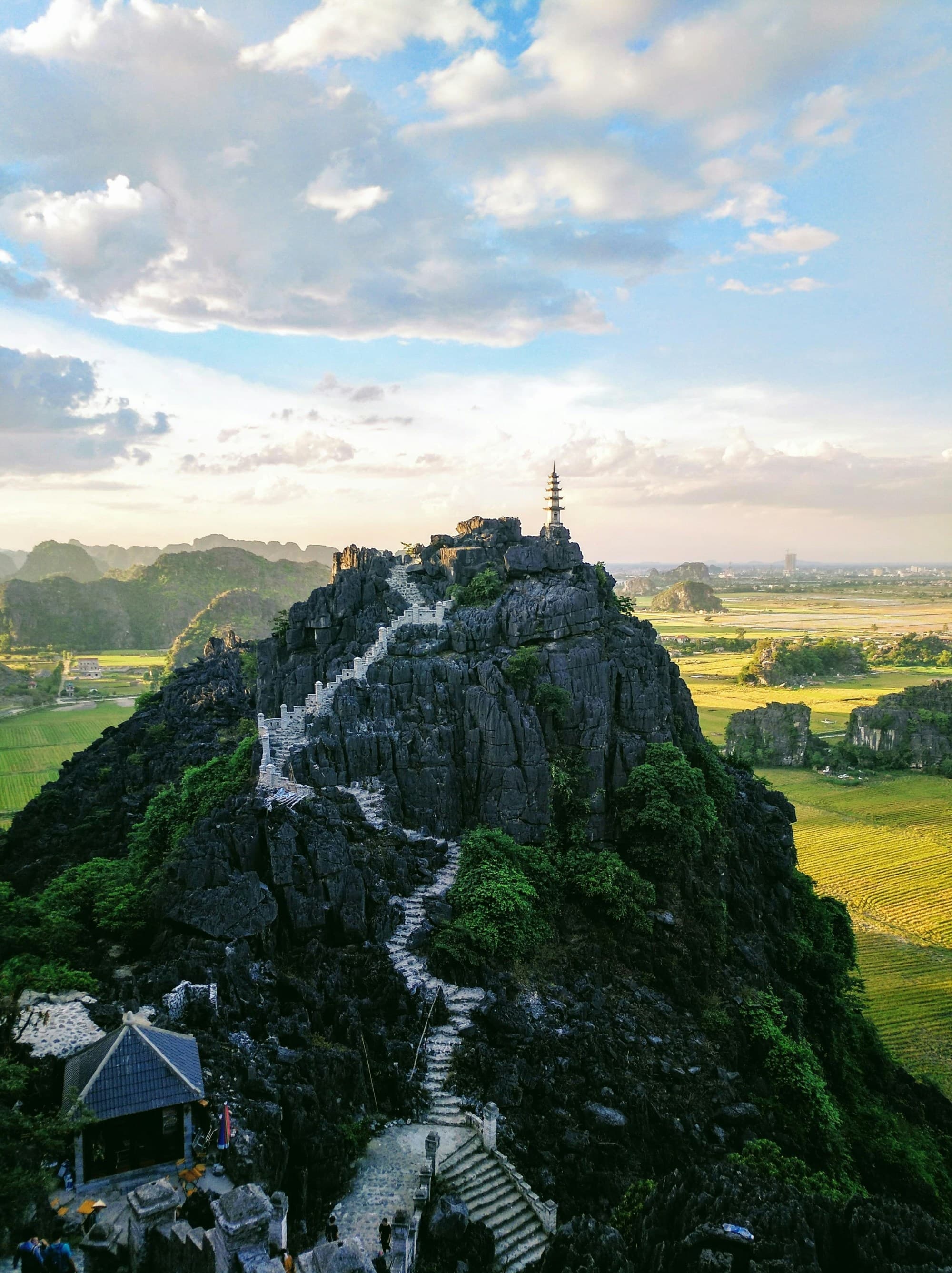 A aerial view of a mountain with steps leading to the top during the daytime