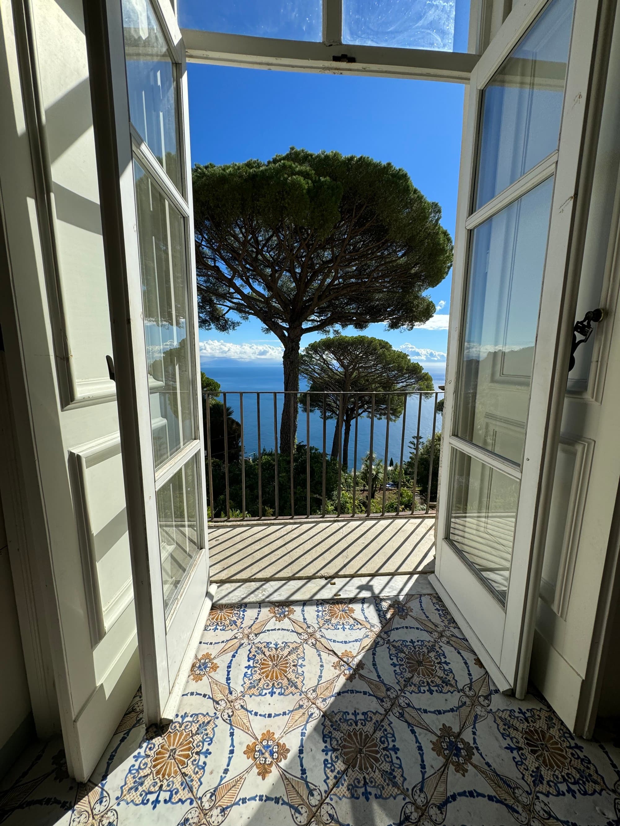 Door opening into terrace with ocean view.