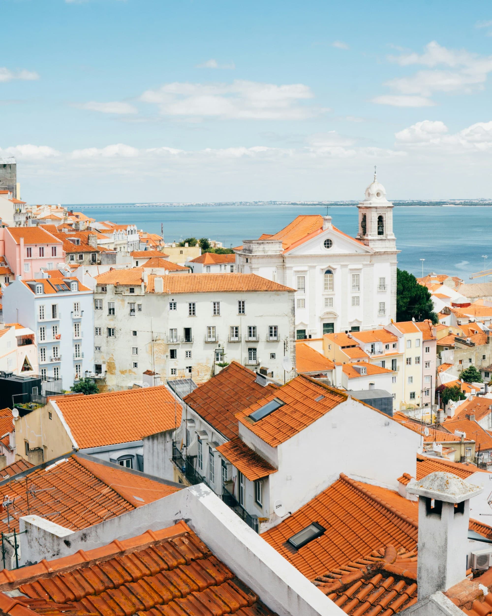 Landscape photography of orange roof houses near body of water.