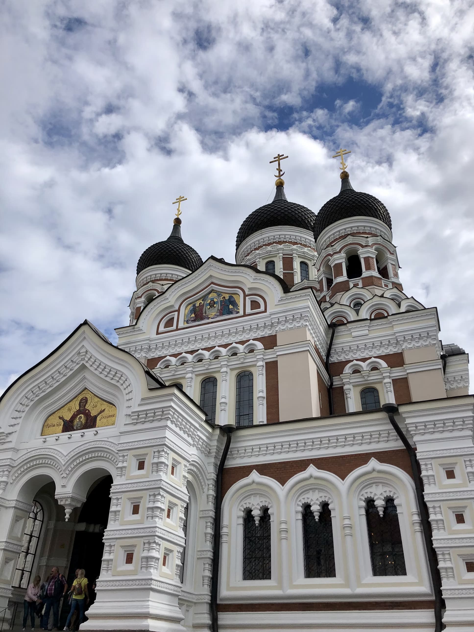 A white church or temple building with domes at the top