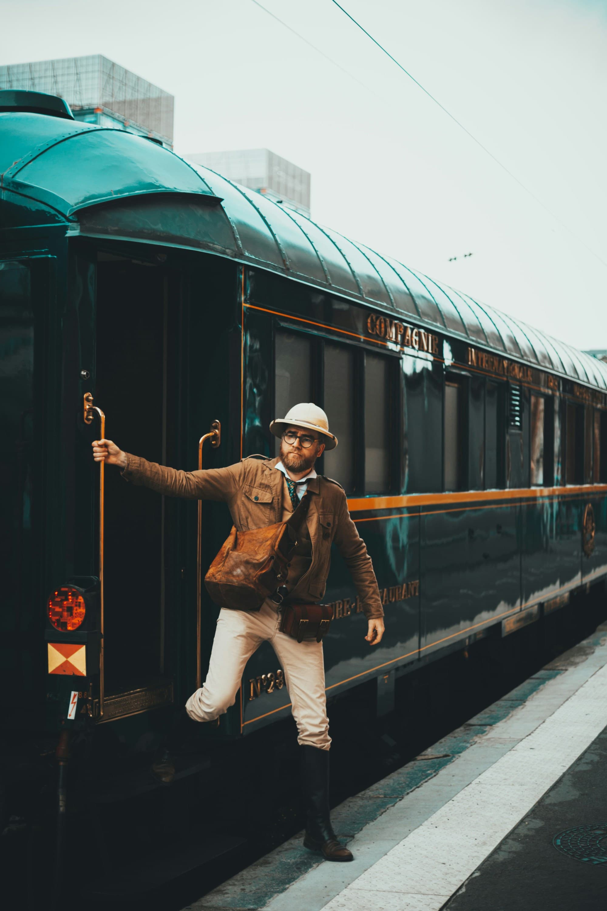 A person stepping off of a train onto a platform