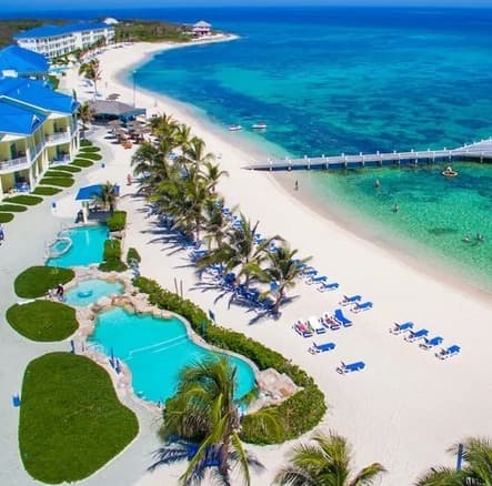 Cayman Islands is the place for luxury and adventure as hotel pools overlook the ocean on a sunny day.