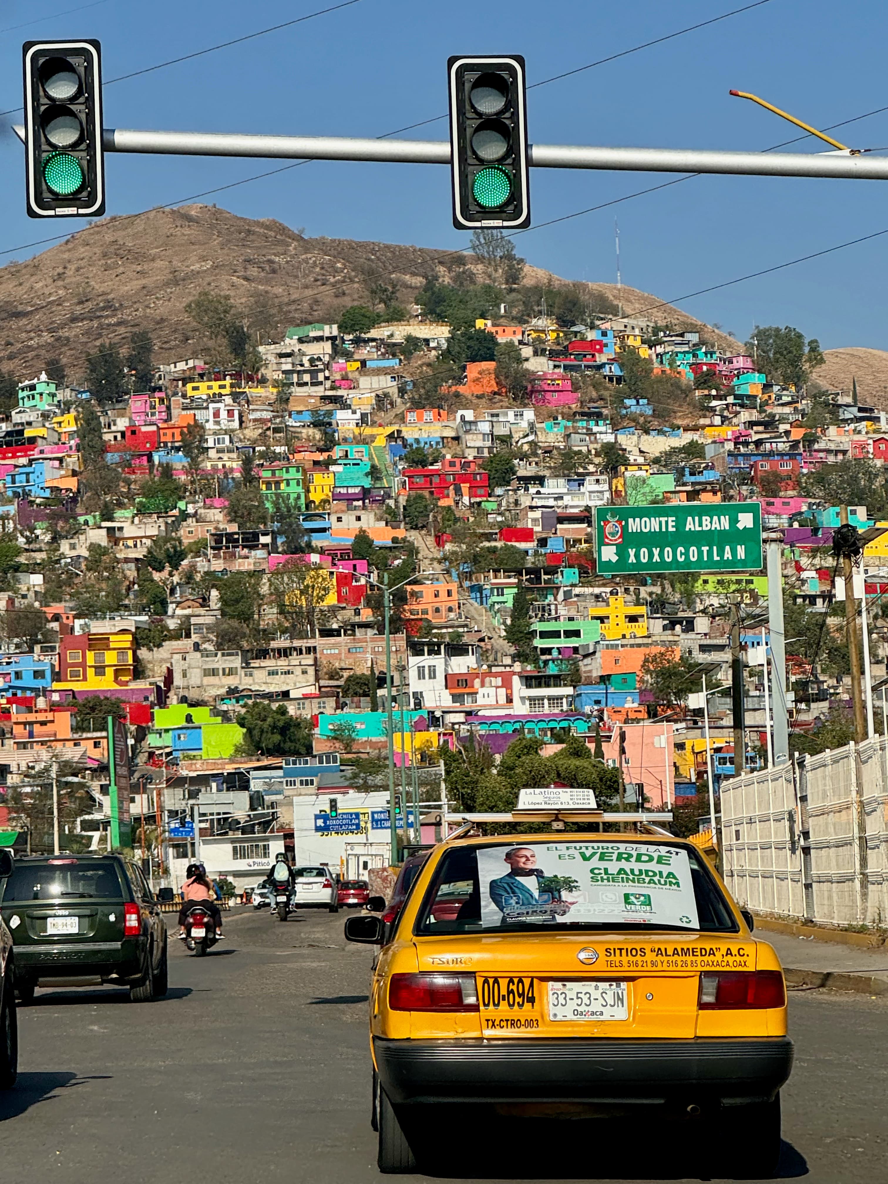 View of colorful buildings by the mountain in Oaxaca.