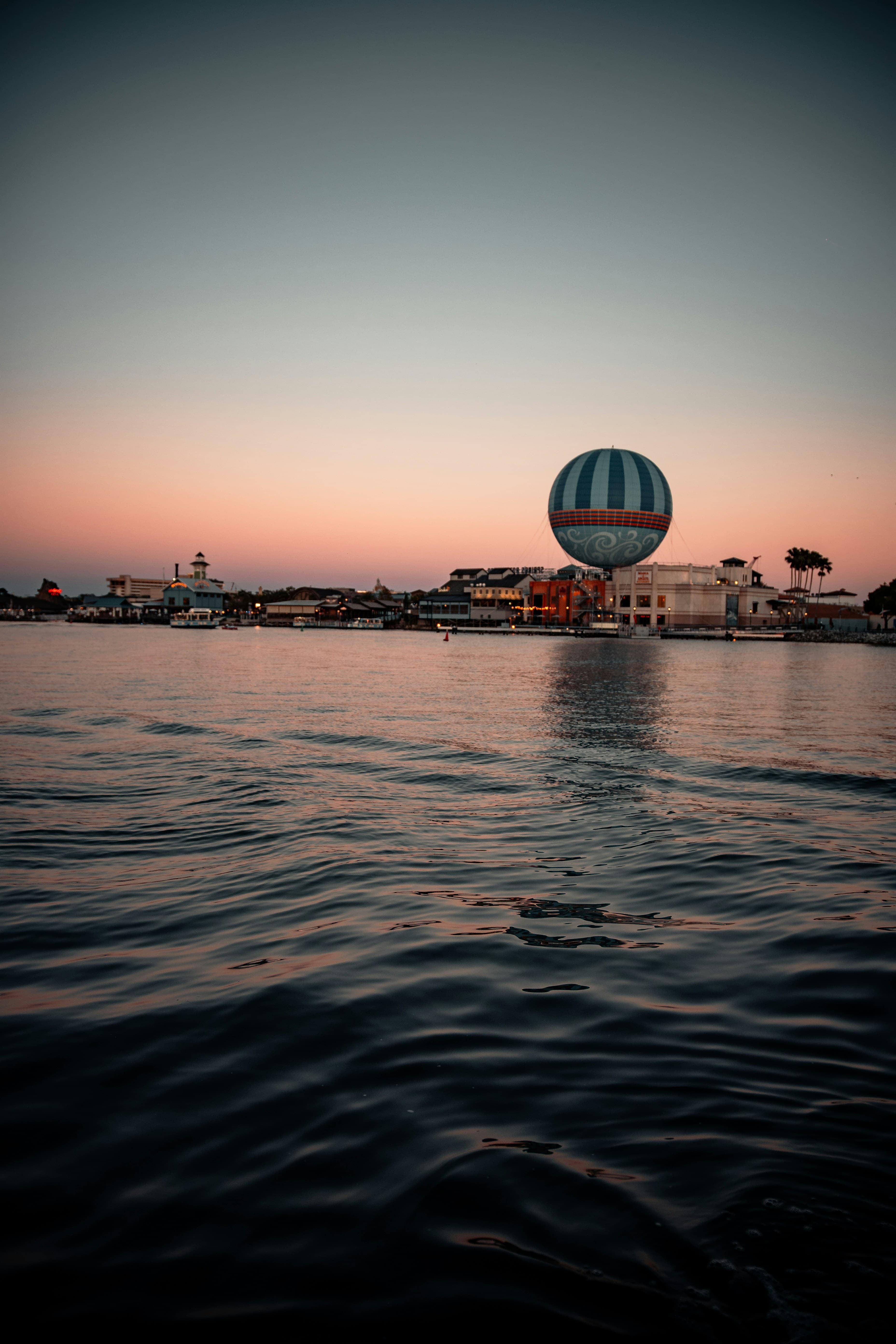 Sunset over the water with a Disney resort in the distance.