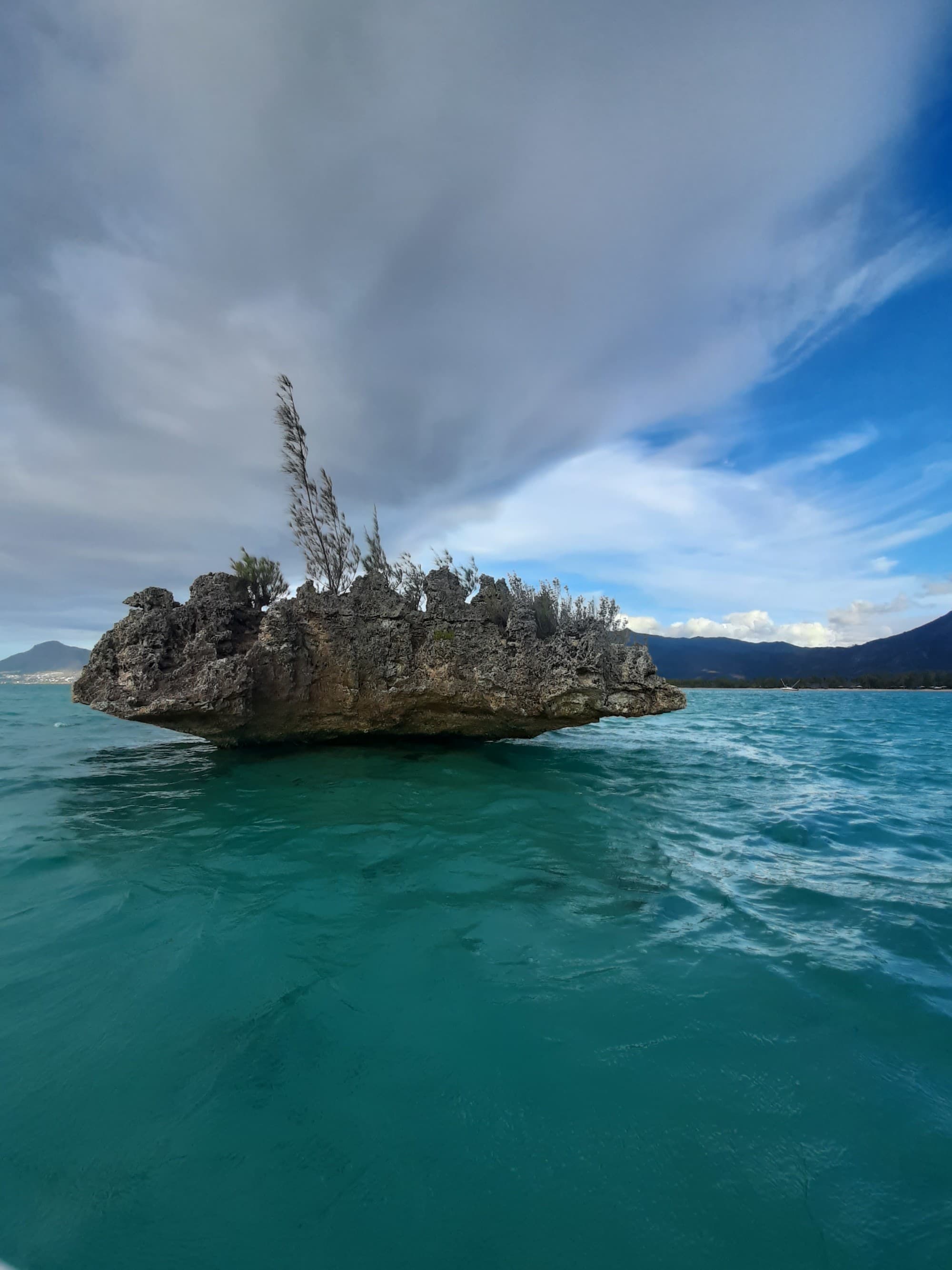 A big rocky structure in sea.