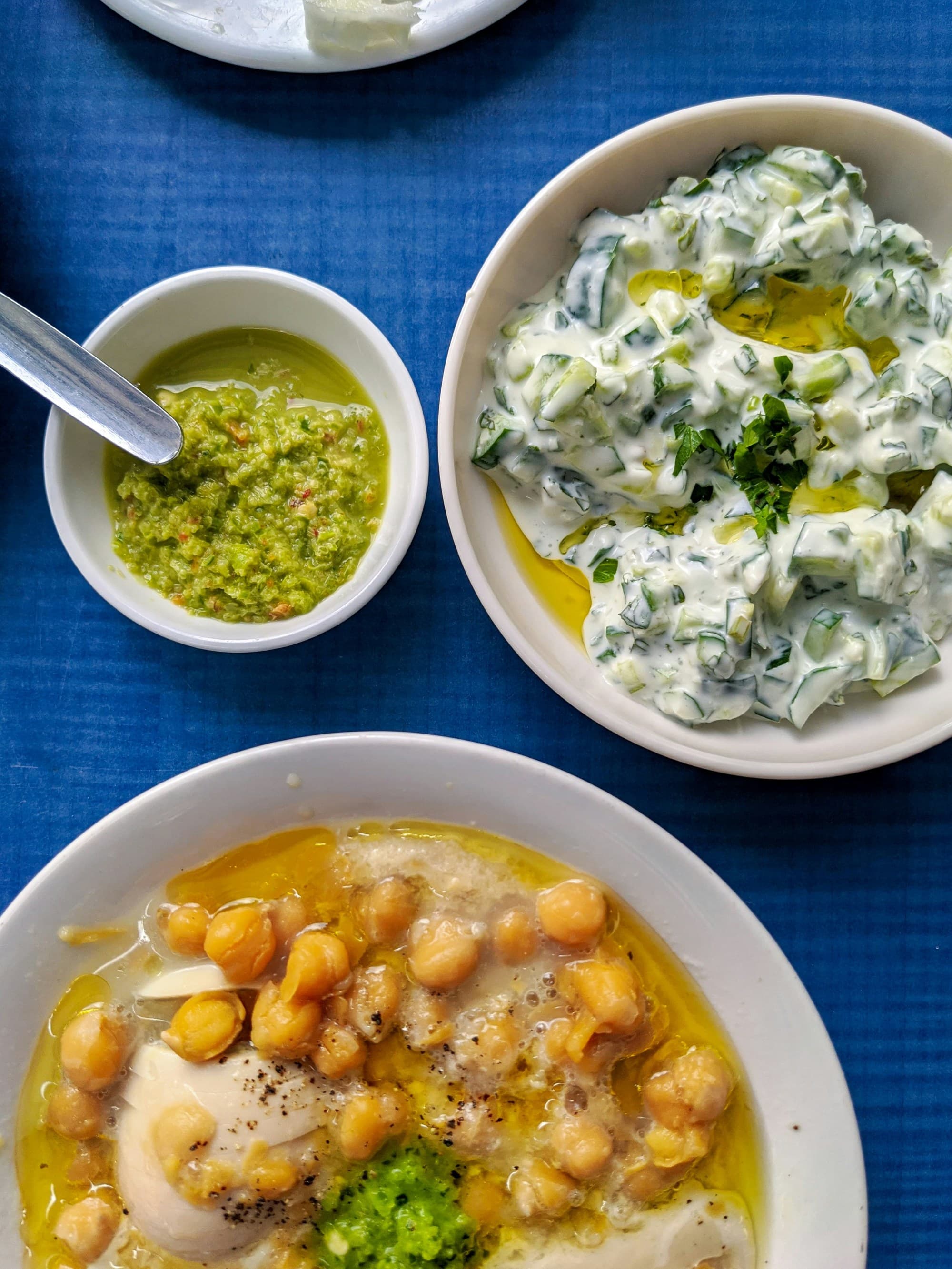 White ceramic bowls with yellow and green dishes.