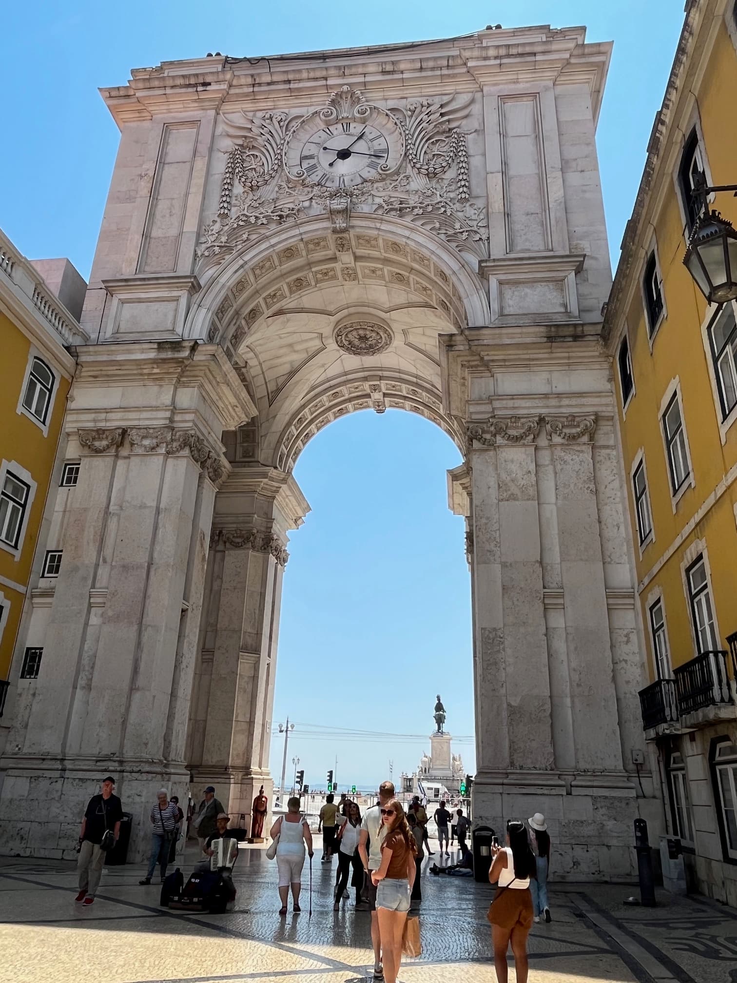 A tall, arched structure between yellow buildings