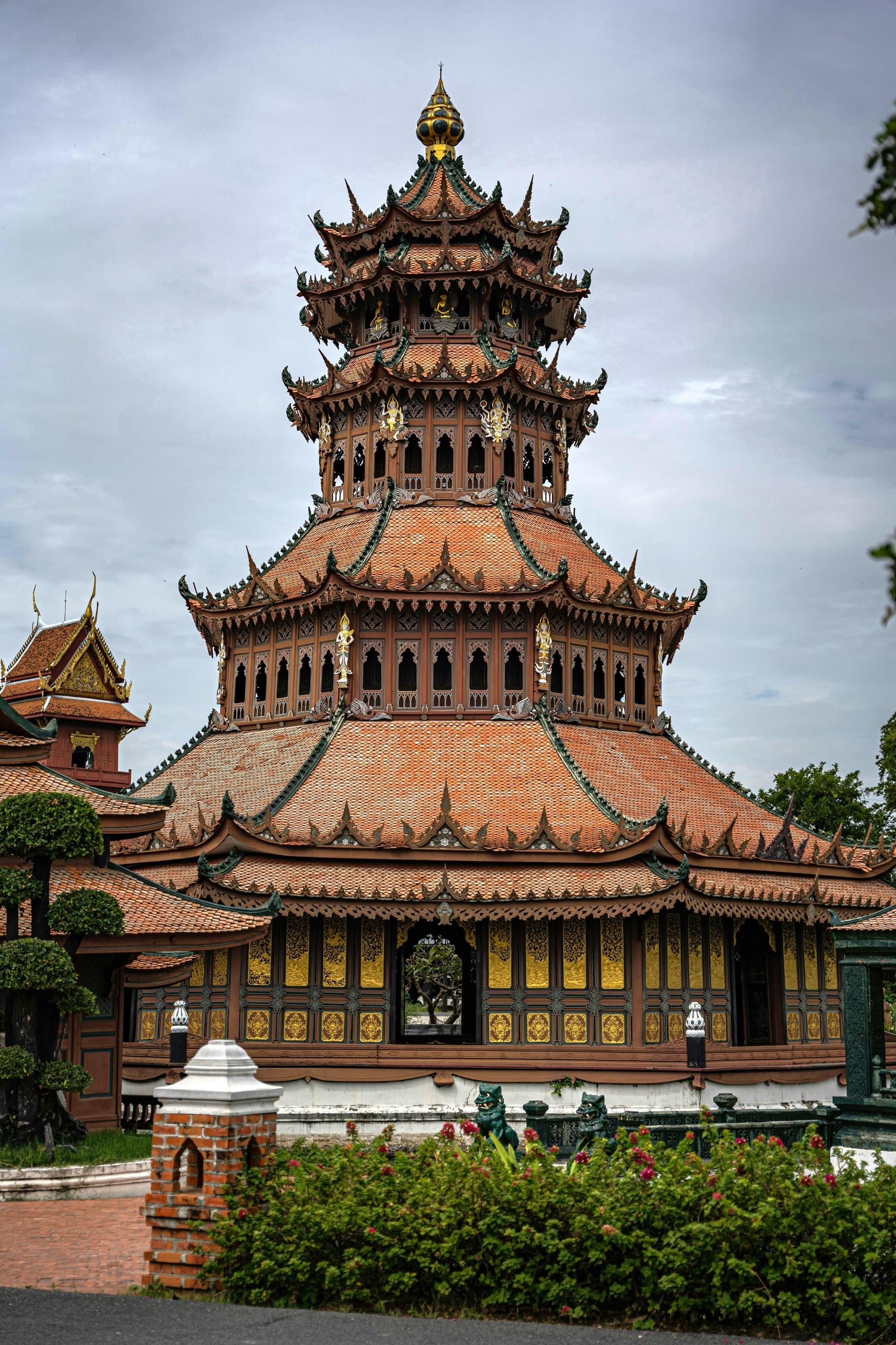 A multi-tiered traditional Asian pagoda stands under an overcast sky.