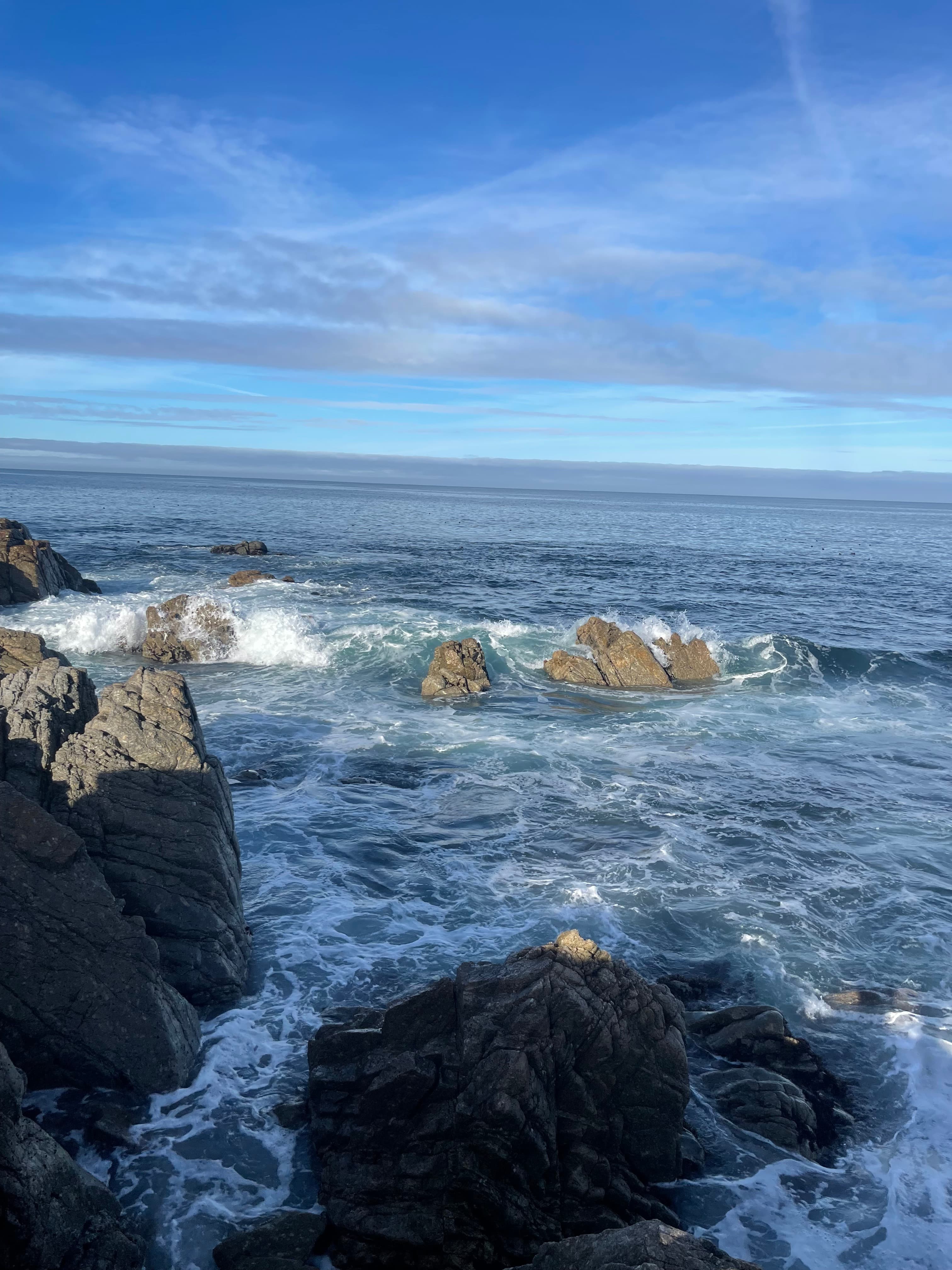 View of a bay of water with large rocks