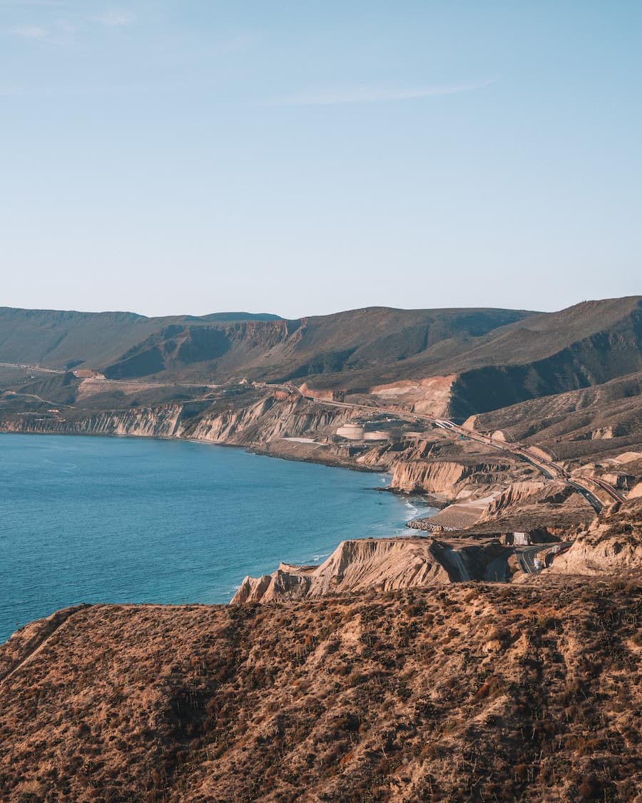 View of a valley next to the sea during the daytime