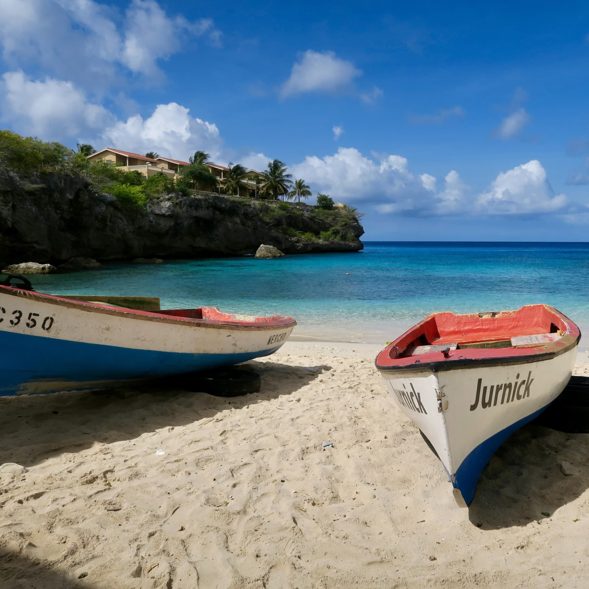 Two boats on a beach during day time.