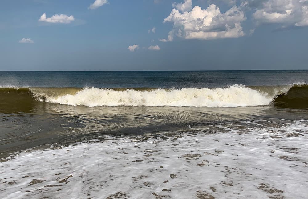 Large waves crashing near the shore at Rehoboth beach.