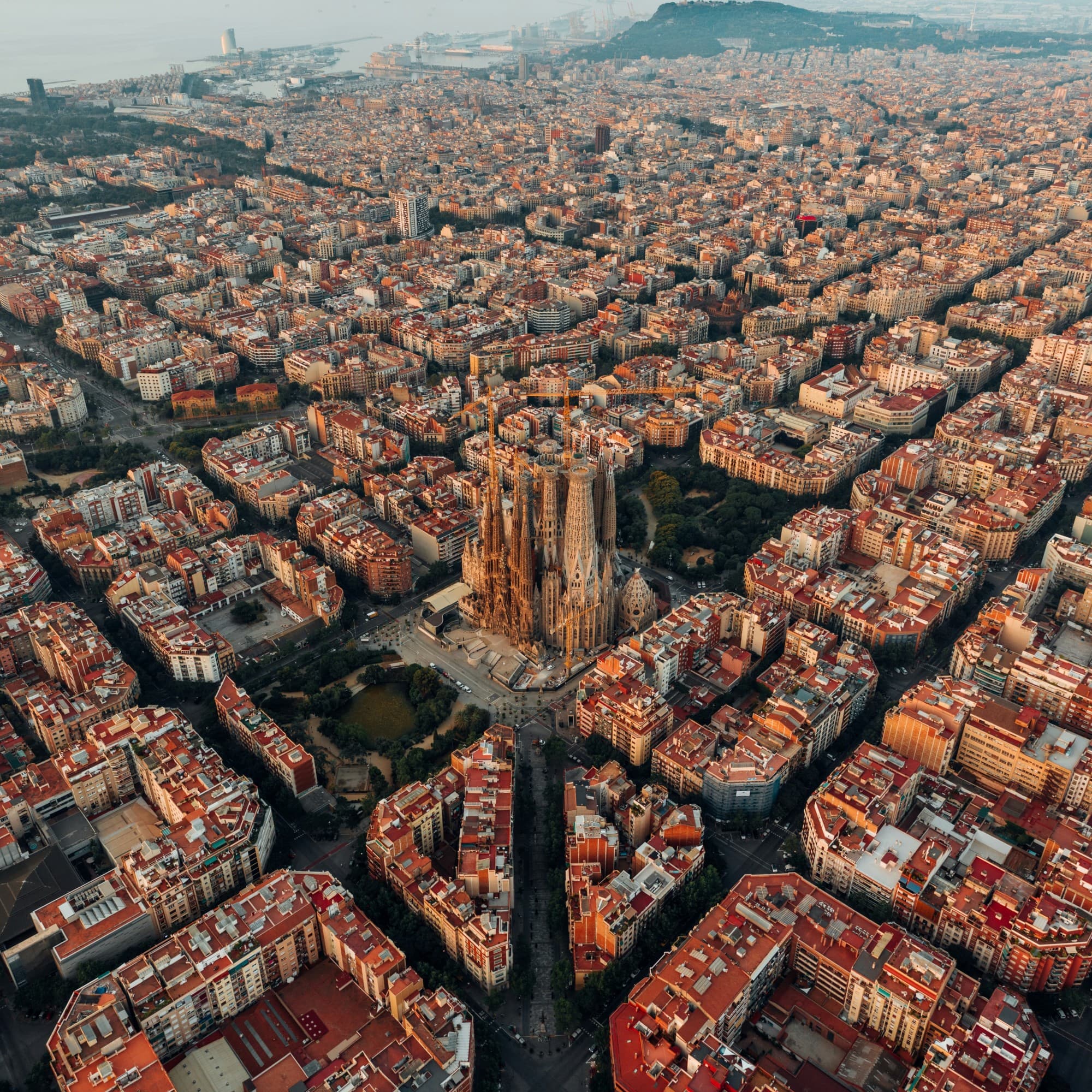 A beautiful aerial view of a grid-like city with a tall building in the middle.