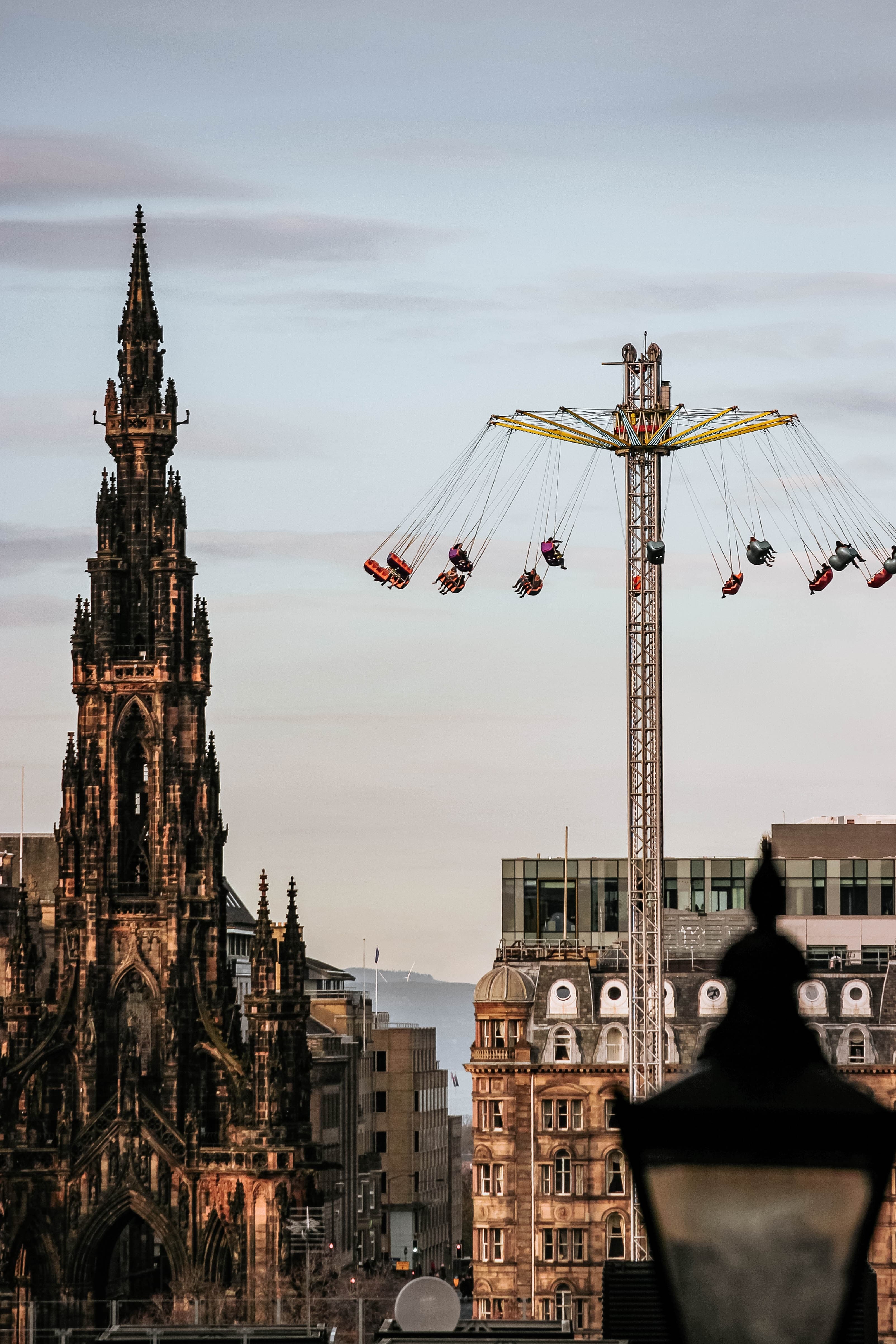 Edinburgh city with a carousel and high ancient towers.