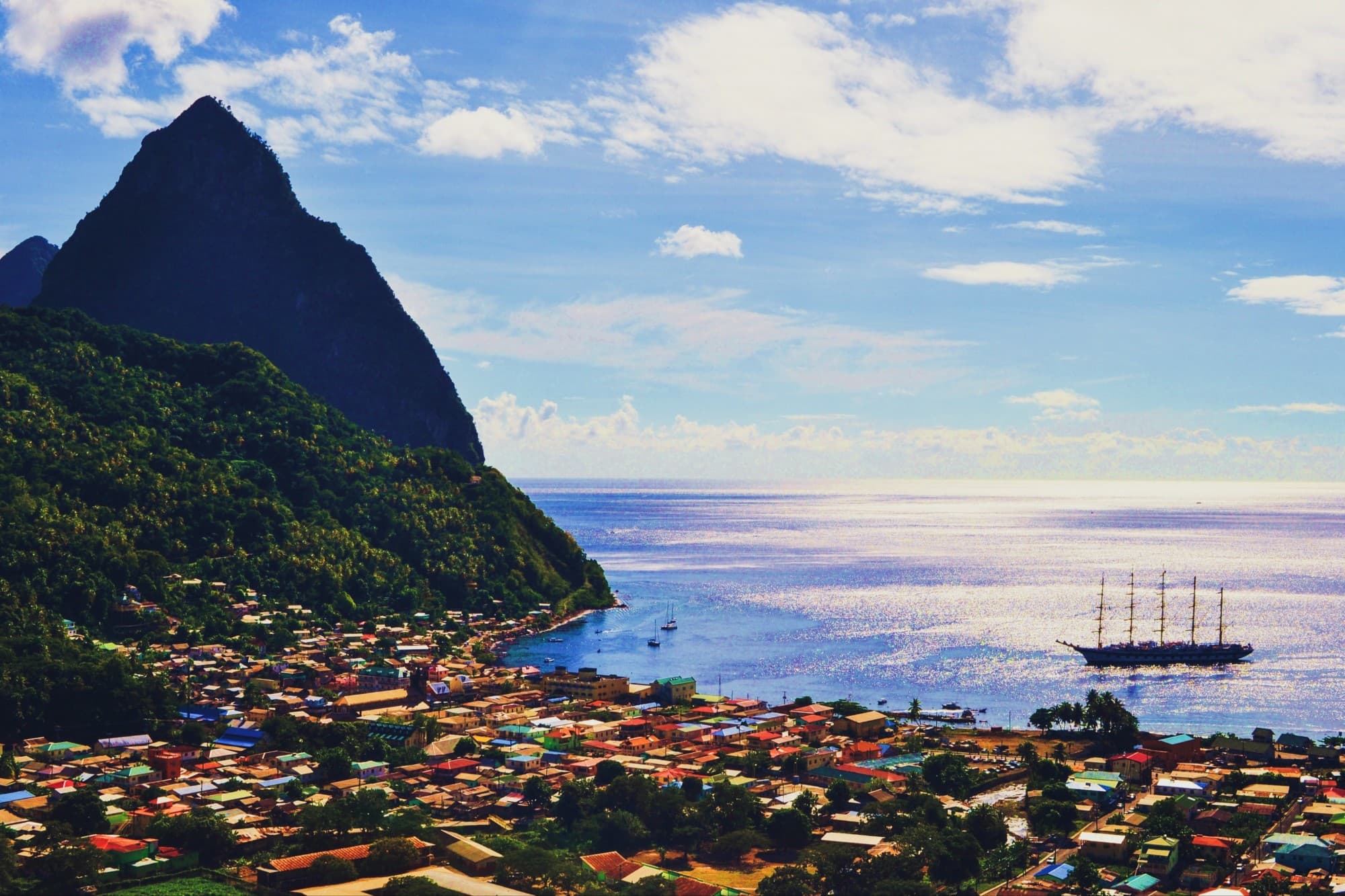 portside city near a large mountain jutting out of the sea