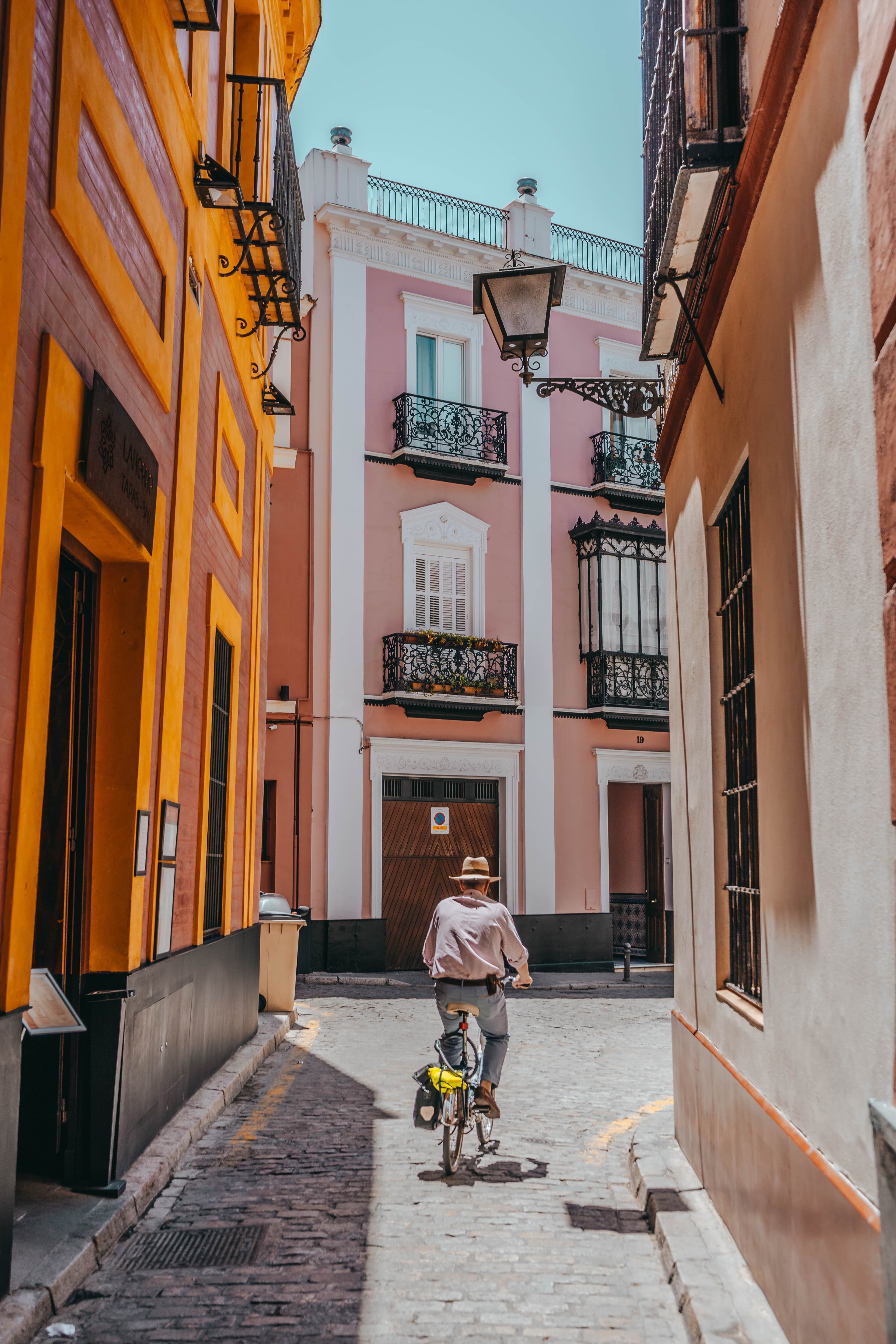 A man riding his bike through Seville, Spain.