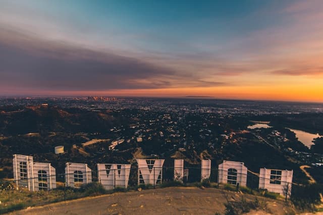 Aerial view of a city behind the famous Hollywood sign