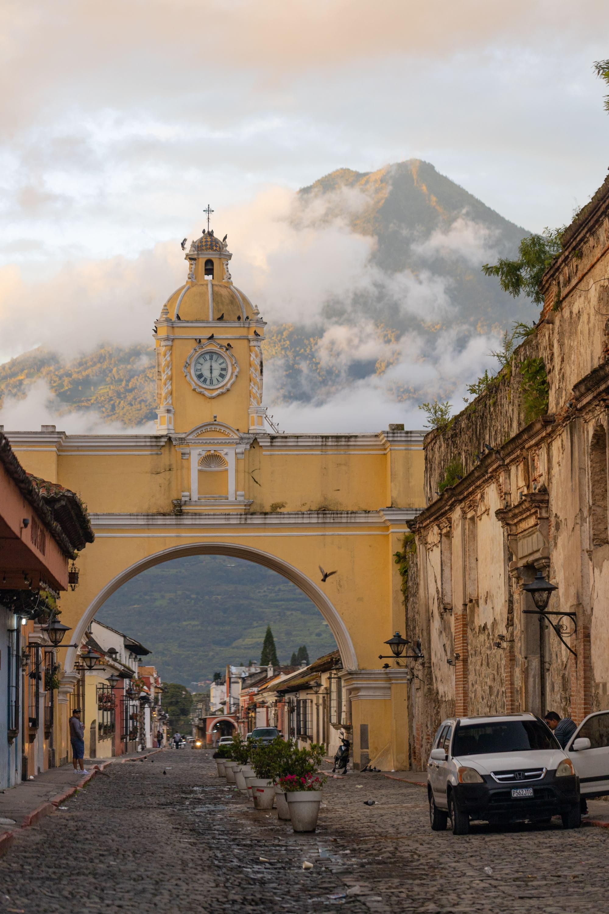 ancient city with yellow arch building and mountain range