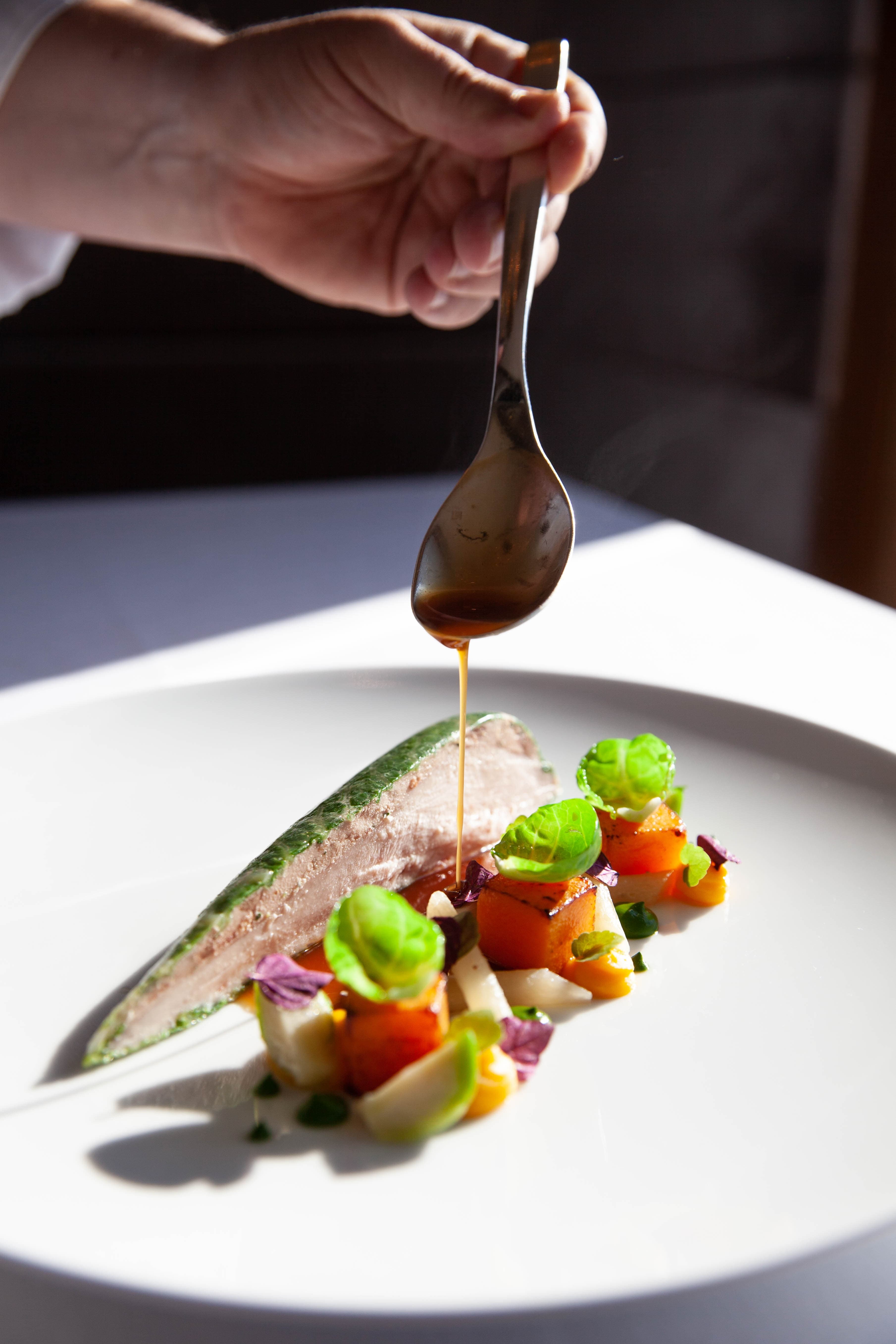 A gourmet dish being plated in Switzerland.