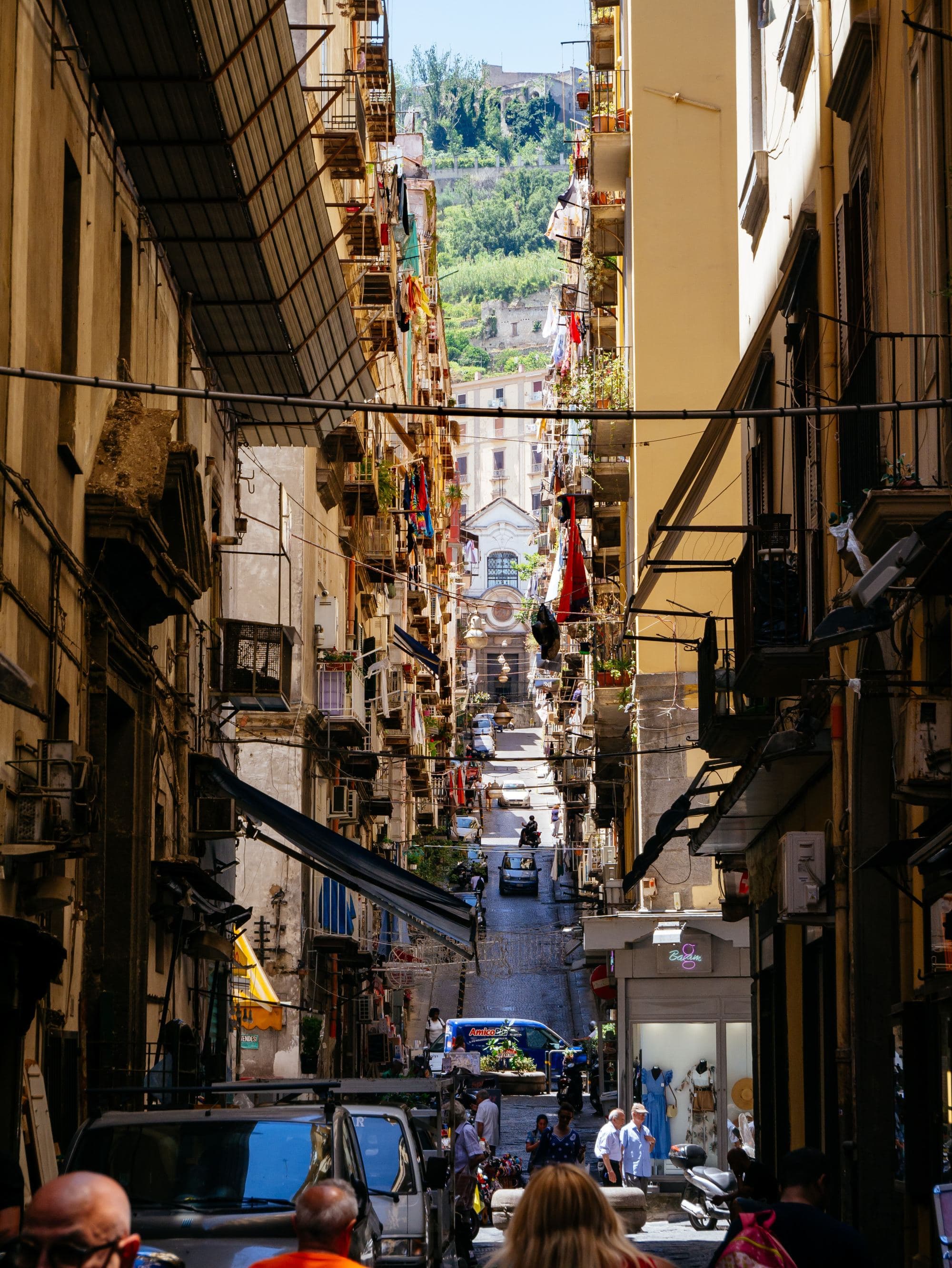 narrow city streets filled with restaurants, shops and pedestrians